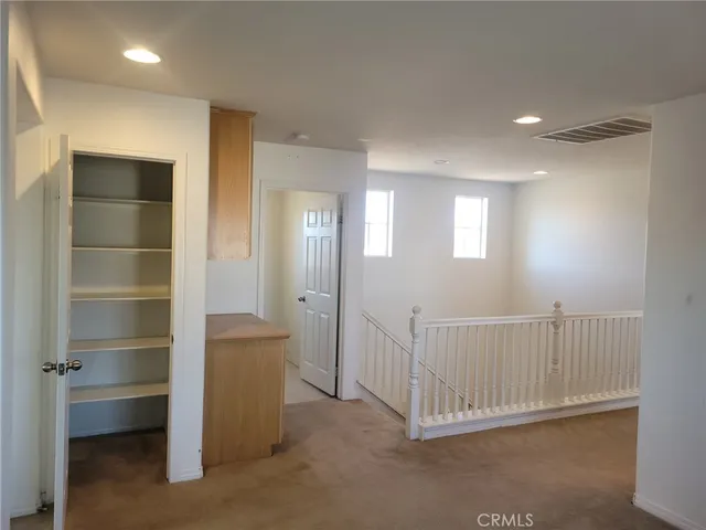 a view of a hallway with closet area