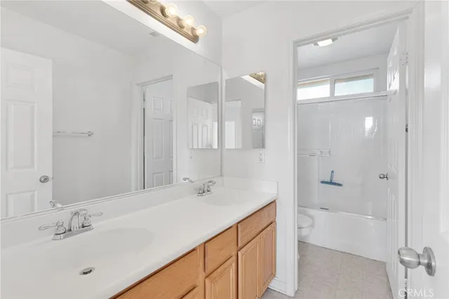 a bathroom with a tub sink shower and mirror