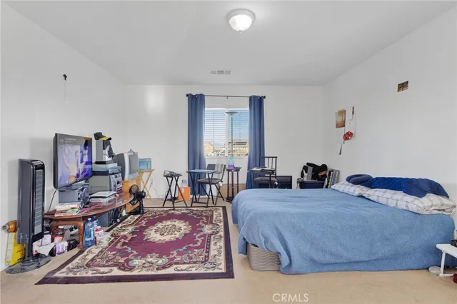 a bedroom with bed and a large window