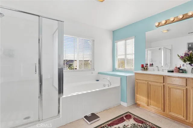 a spacious bathroom with sink shower and bathtub