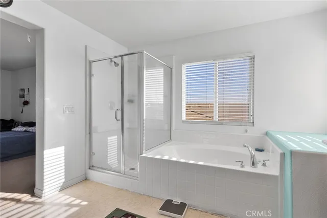 a bathroom with a bathtub and a shower