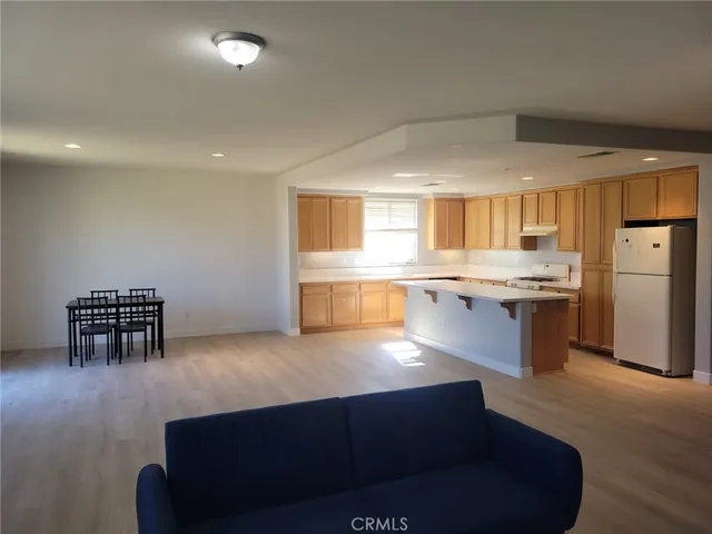 a kitchen with stainless steel appliances granite countertop a refrigerator a stove and a sink with granite countertops