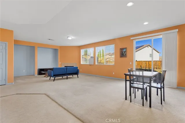 a view of work space with windows and furniture