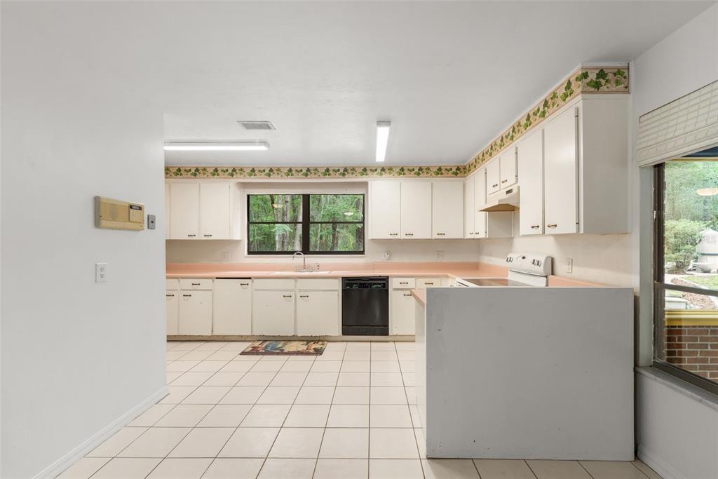 4703 Northwest 124th Street Gainesville, FL 32606 - Photo 21 of 55 a kitchen with a sink cabinets and window