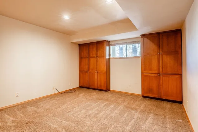 a view of a livingroom with wooden floor and a ceiling fan