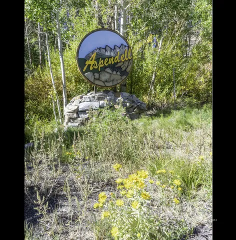 a living room with a fireplace and large windows