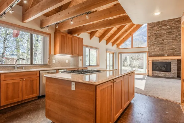 a kitchen with stainless steel appliances granite countertop a sink and a stove