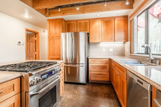 a kitchen with a stove and a window