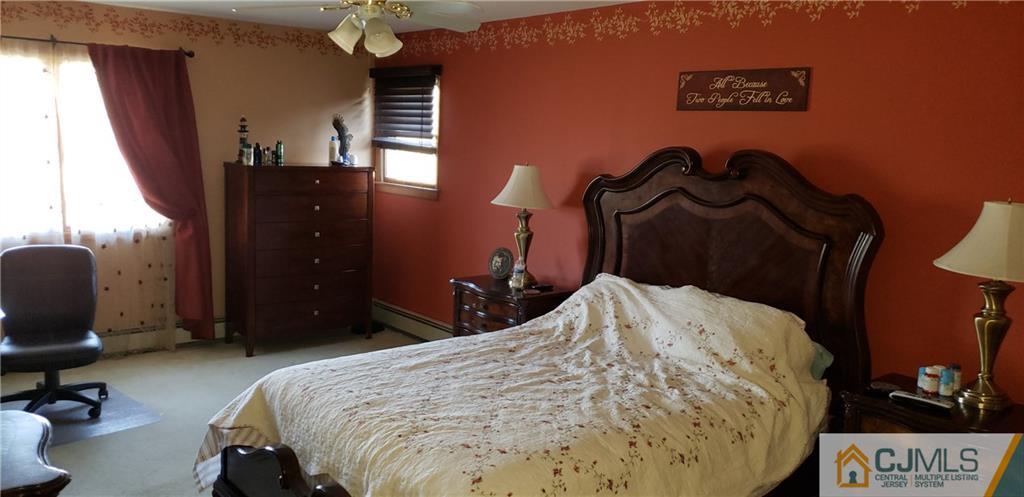 104 Rymon Road Washington, NJ 07882 - Photo 14 of 25 a bedroom with a bed and a chandelier