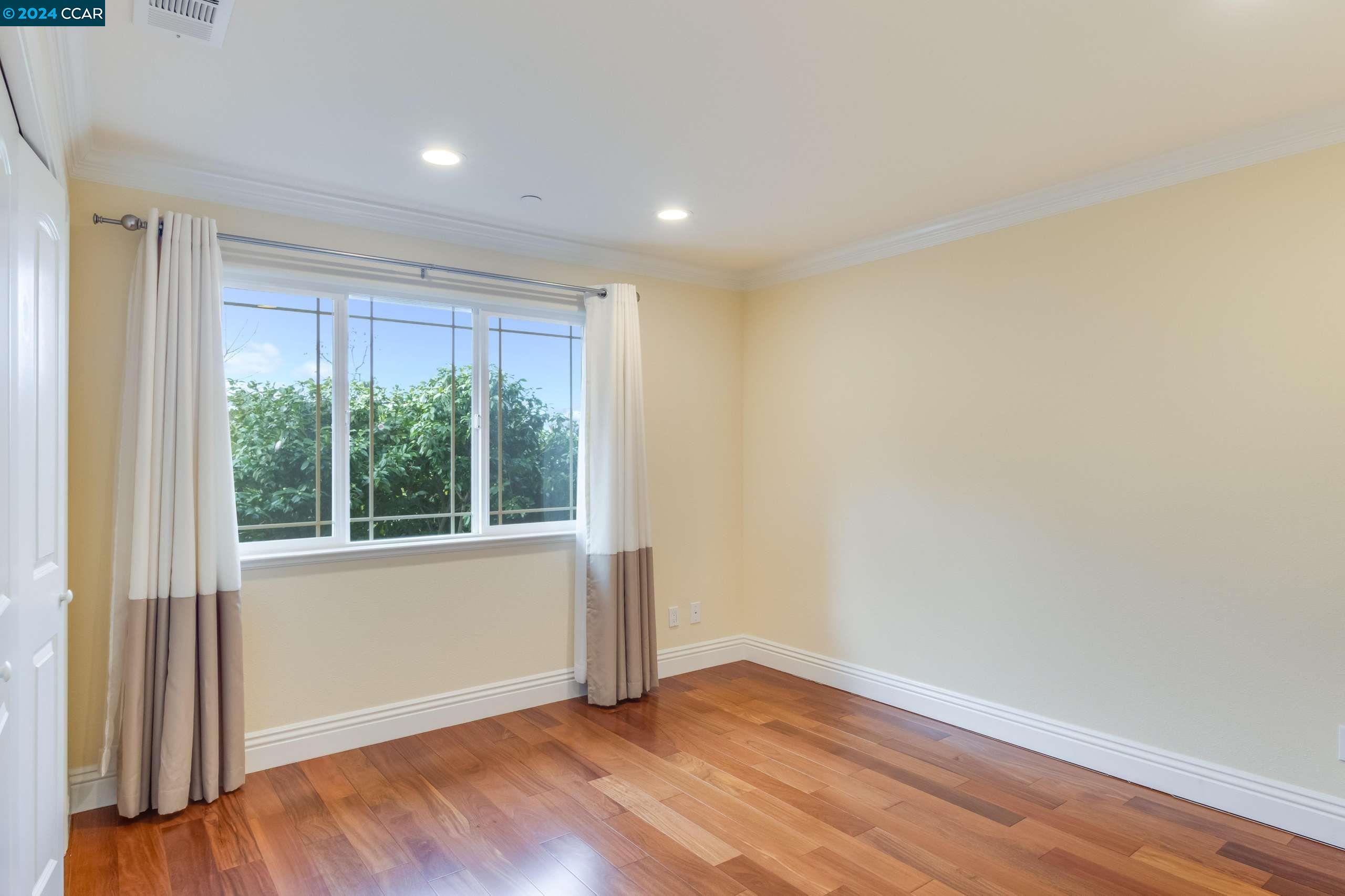 540 Helen Drive Millbrae, CA 94030 - Photo 14 of 24 a view of an empty room with wooden floor and a window