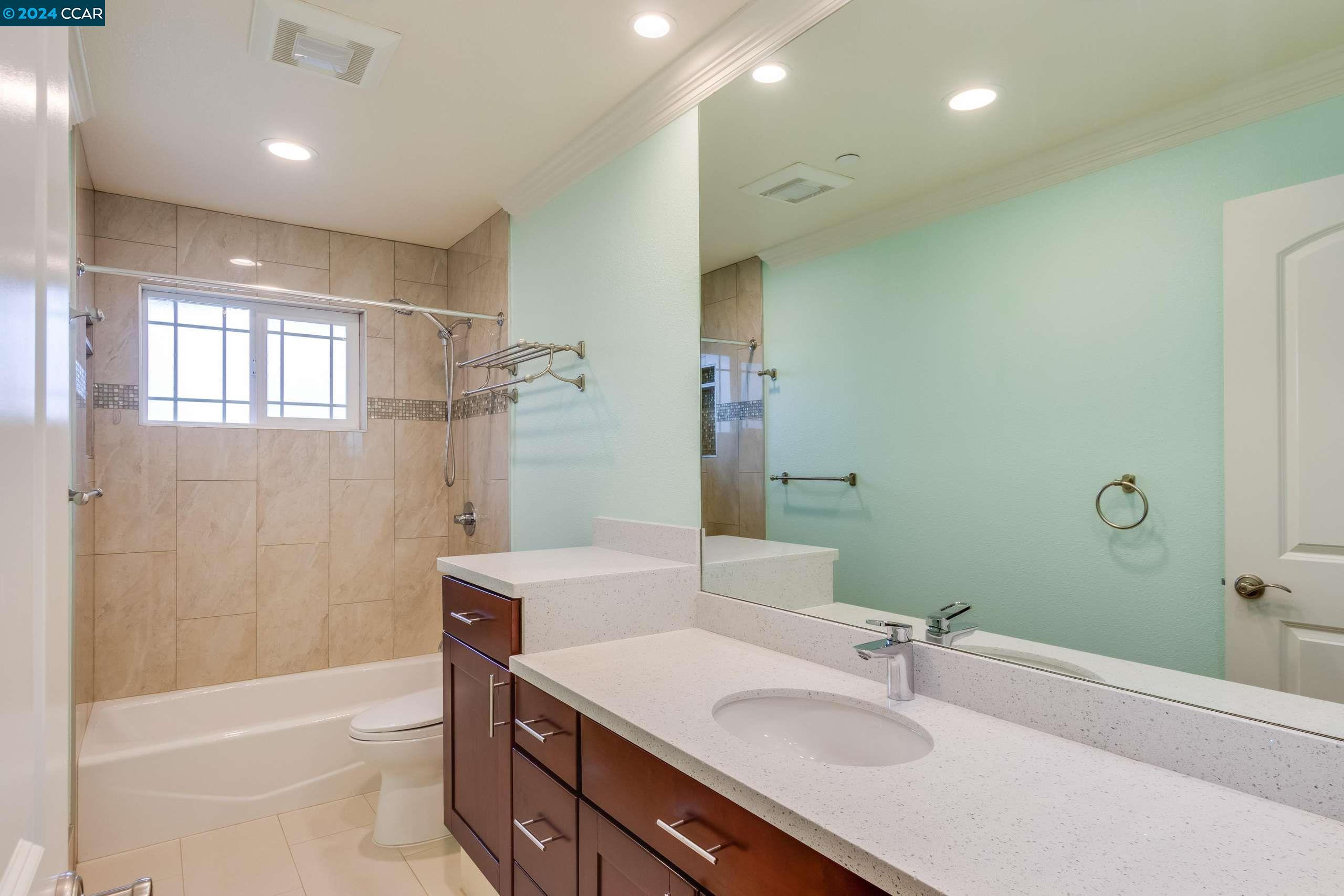540 Helen Drive Millbrae, CA 94030 - Photo 15 of 24 a bathroom with a sink double vanity granite tub shower and a mirror