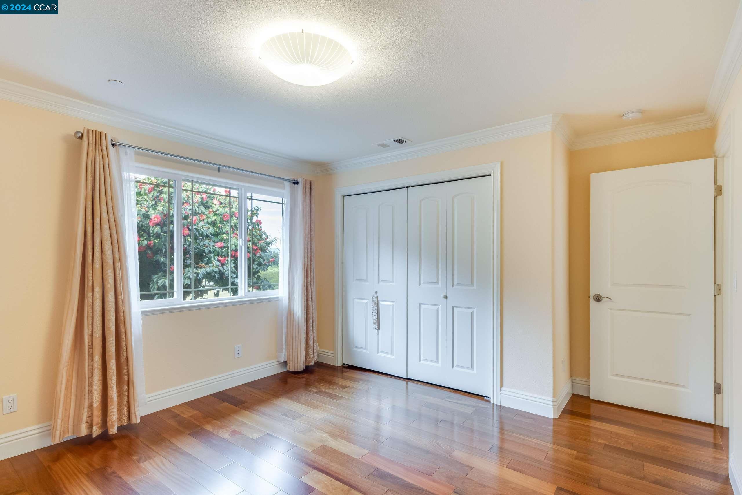 540 Helen Drive Millbrae, CA 94030 - Photo 16 of 24 an empty room with wooden floor and windows