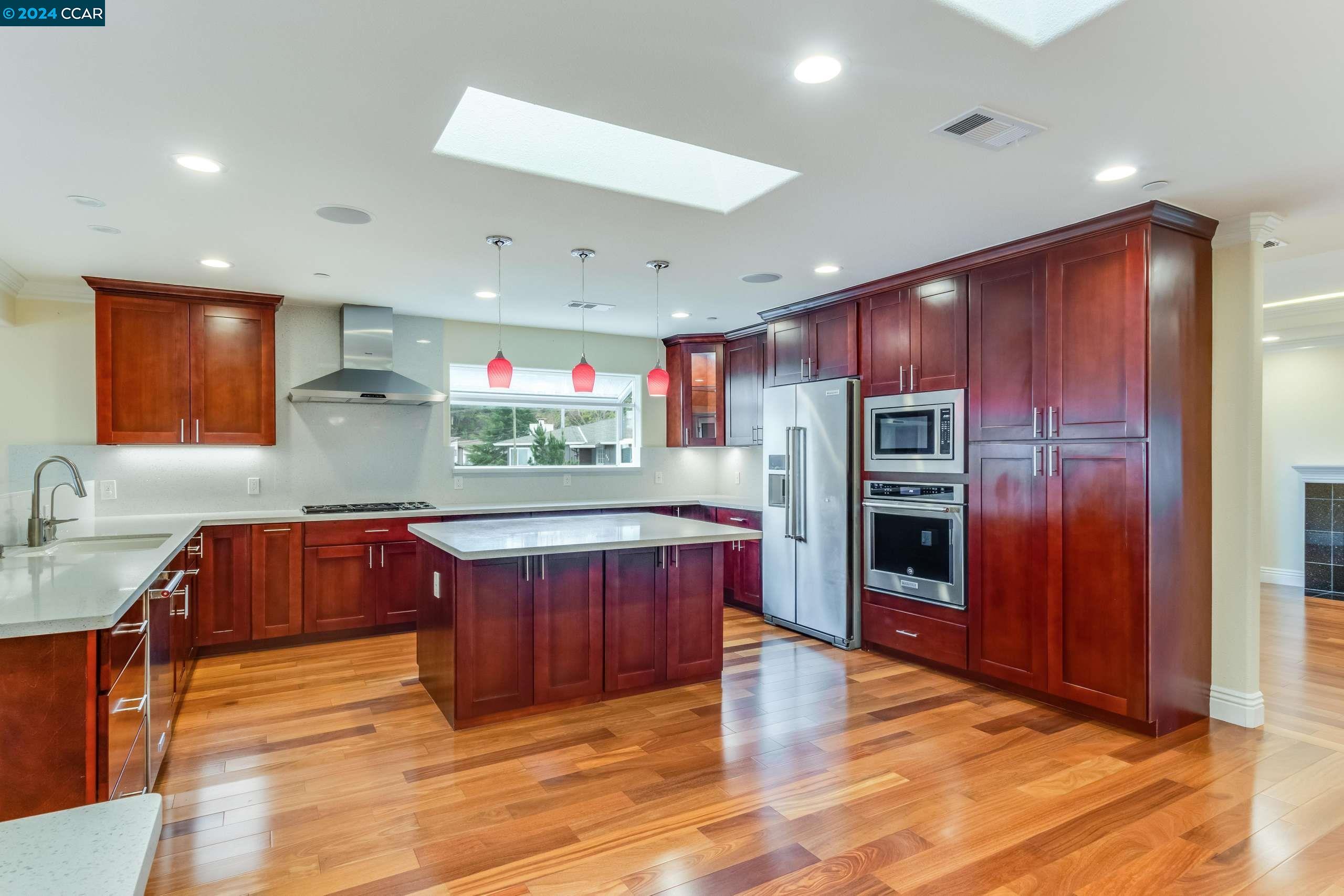 540 Helen Drive Millbrae, CA 94030 - Photo 6 of 24 a kitchen with stainless steel appliances kitchen island granite countertop a refrigerator and a stove top oven