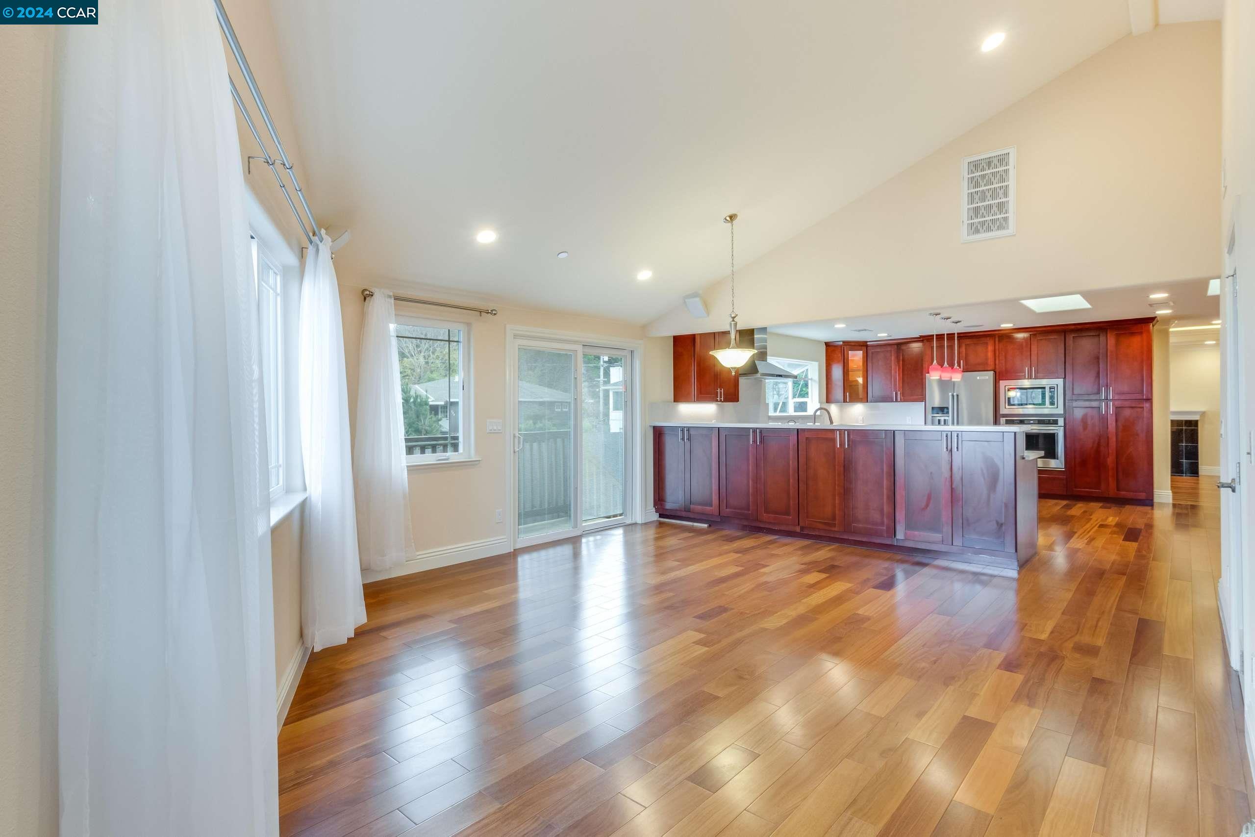 540 Helen Drive Millbrae, CA 94030 - Photo 9 of 24 a view of a big room with wooden floor and windows