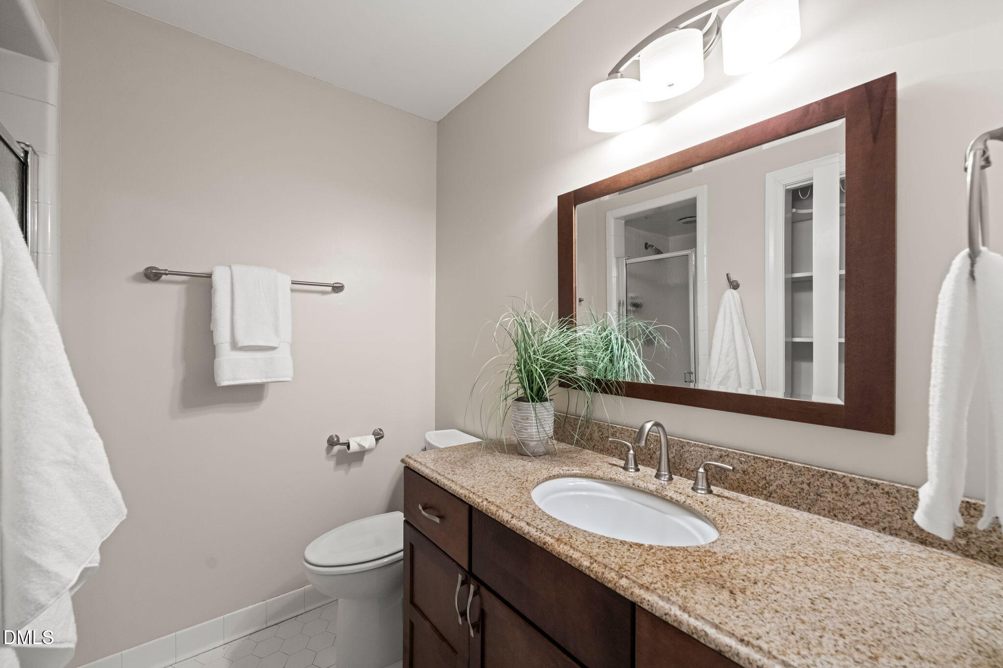 18 Strawberry Ridge Lane Durham, NC 27713 - Photo 29 of 59 a bathroom with a granite countertop sink a toilet and mirror