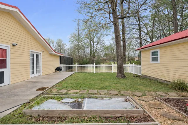 a front view of a house with a yard and trees