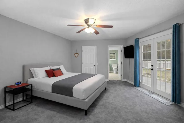 a bedroom with a large bed and a chandelier