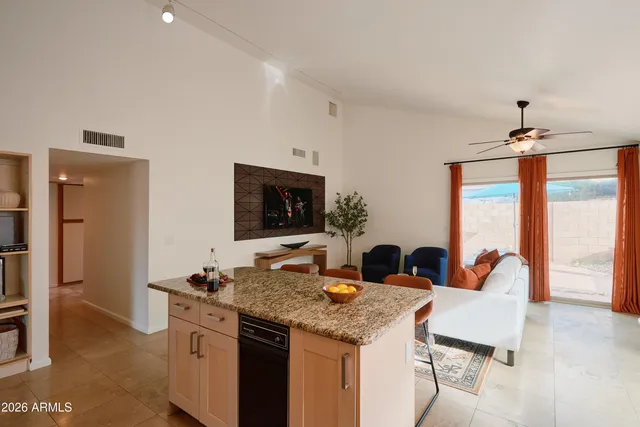 a view of a kitchen area with furniture and wooden floor