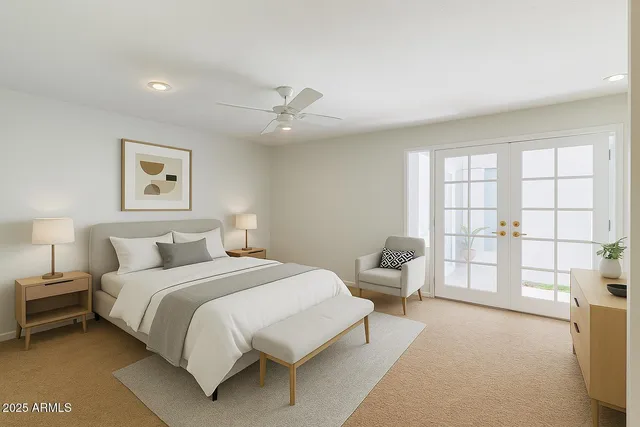 a bedroom with a large bed and a window