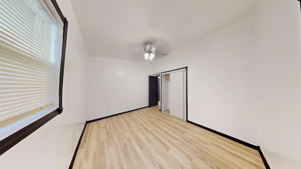 a view of a room with wooden floor and white walls