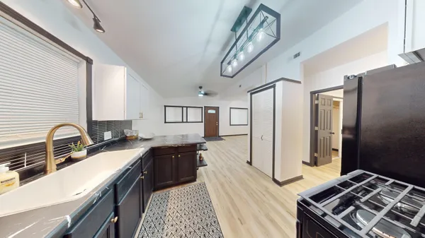 a kitchen with a sink stove and refrigerator