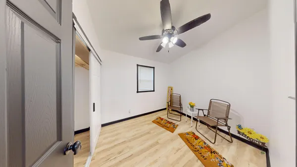 a room with a bed and wooden floor