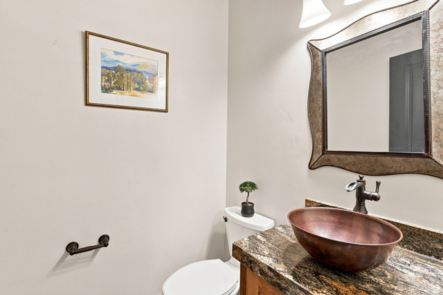 5207 North Oldgate Road Heber City, UT 84032 - Photo 16 of 58 Vanity with a copper vessel sink, dark-toned faucet, and a stone countertop