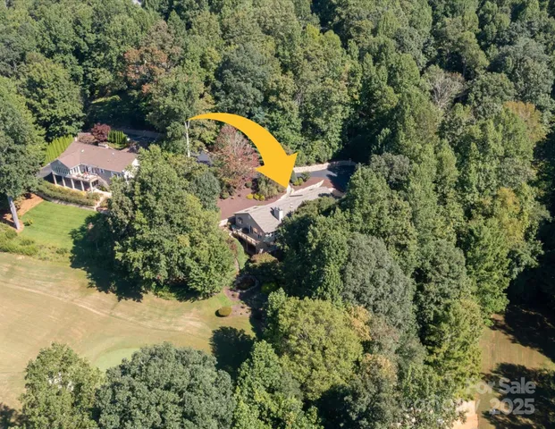 a living room with furniture and floor to ceiling windows