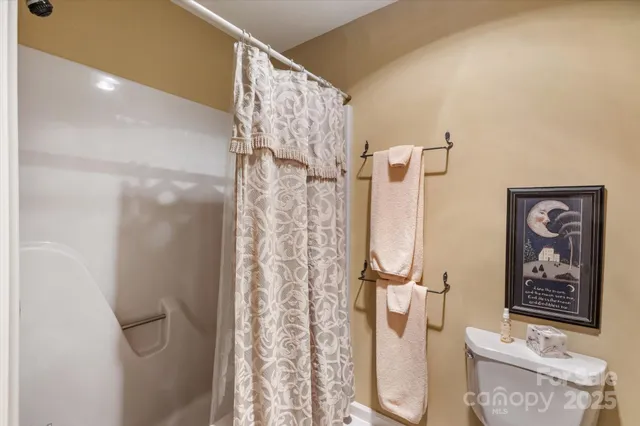 an aerial view of residential house with outdoor space and trees all around