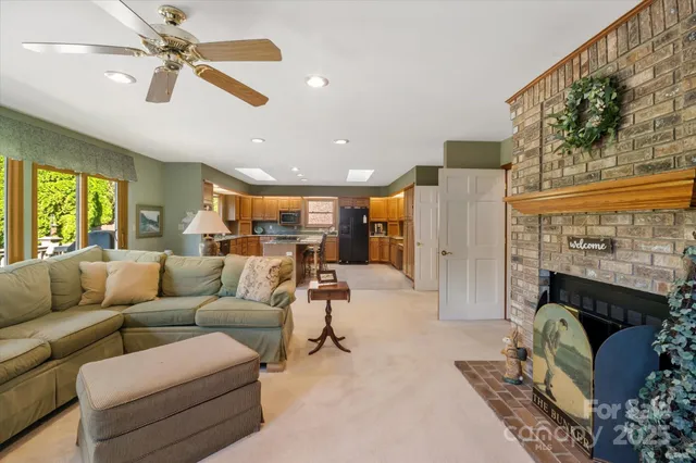 a kitchen with stainless steel appliances granite countertop a refrigerator a stove a sink a dining table and chairs