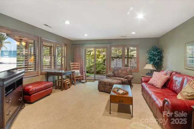 a kitchen with granite countertop a sink window and cabinets