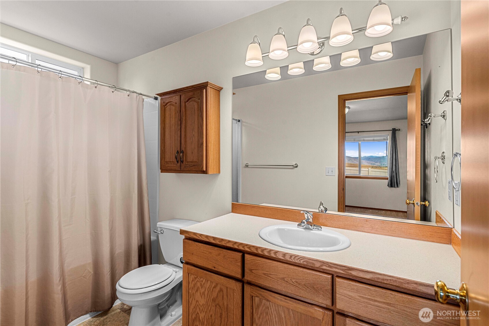 1308 Tractor Loop East Wenatchee, WA 98802 - Photo 17 of 35 a bathroom with a sink a toilet and a mirror
