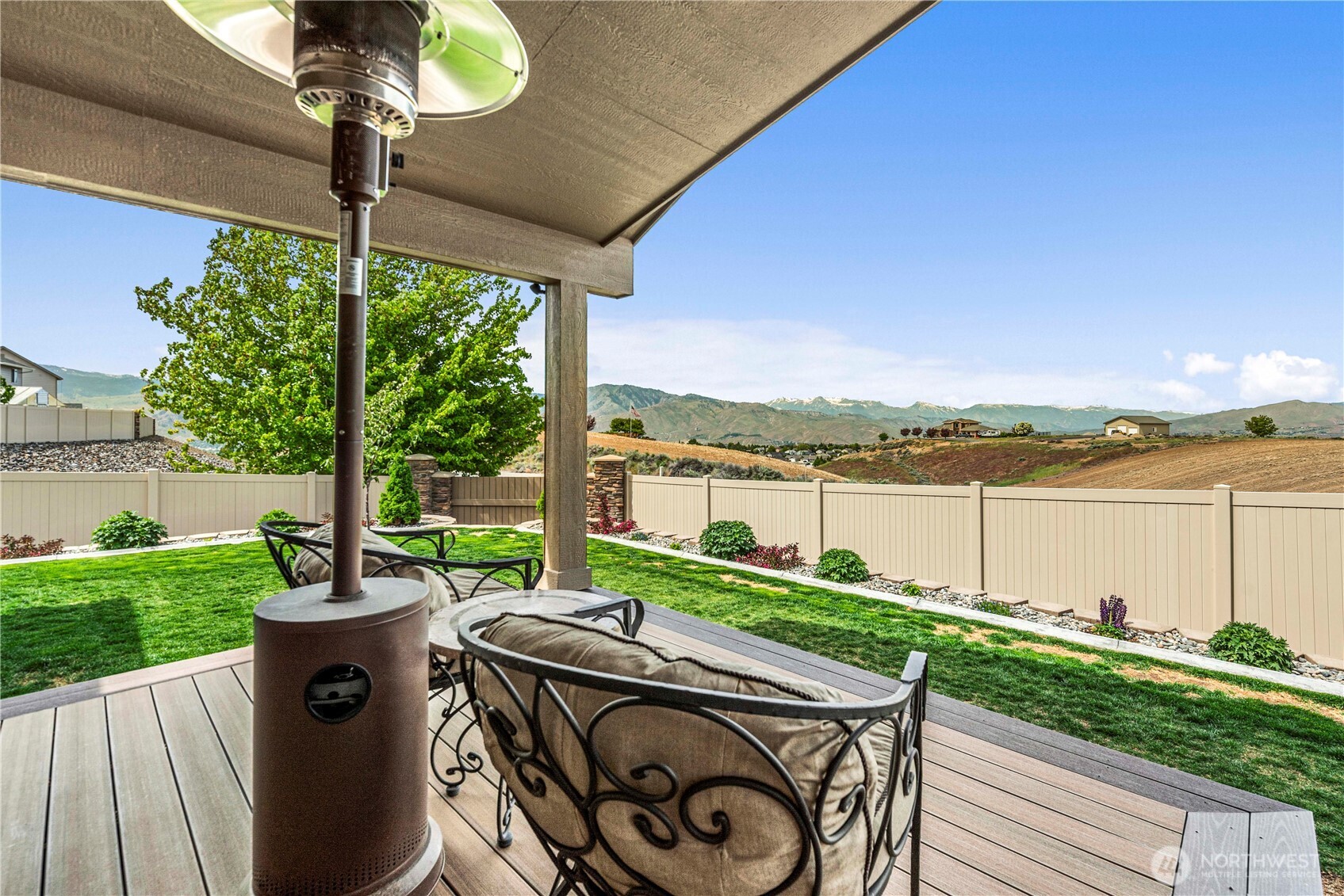 1308 Tractor Loop East Wenatchee, WA 98802 - Photo 26 of 35 a view of a deck with a table and chairs next to a yard