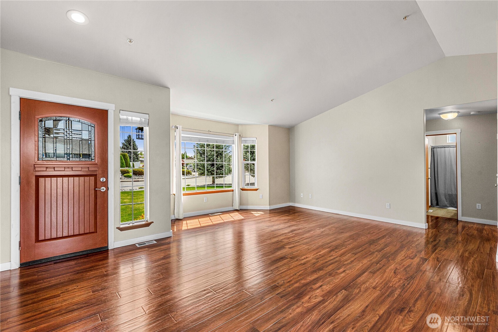 1308 Tractor Loop East Wenatchee, WA 98802 - Photo 5 of 35 a view of an empty room with wooden floor and a window