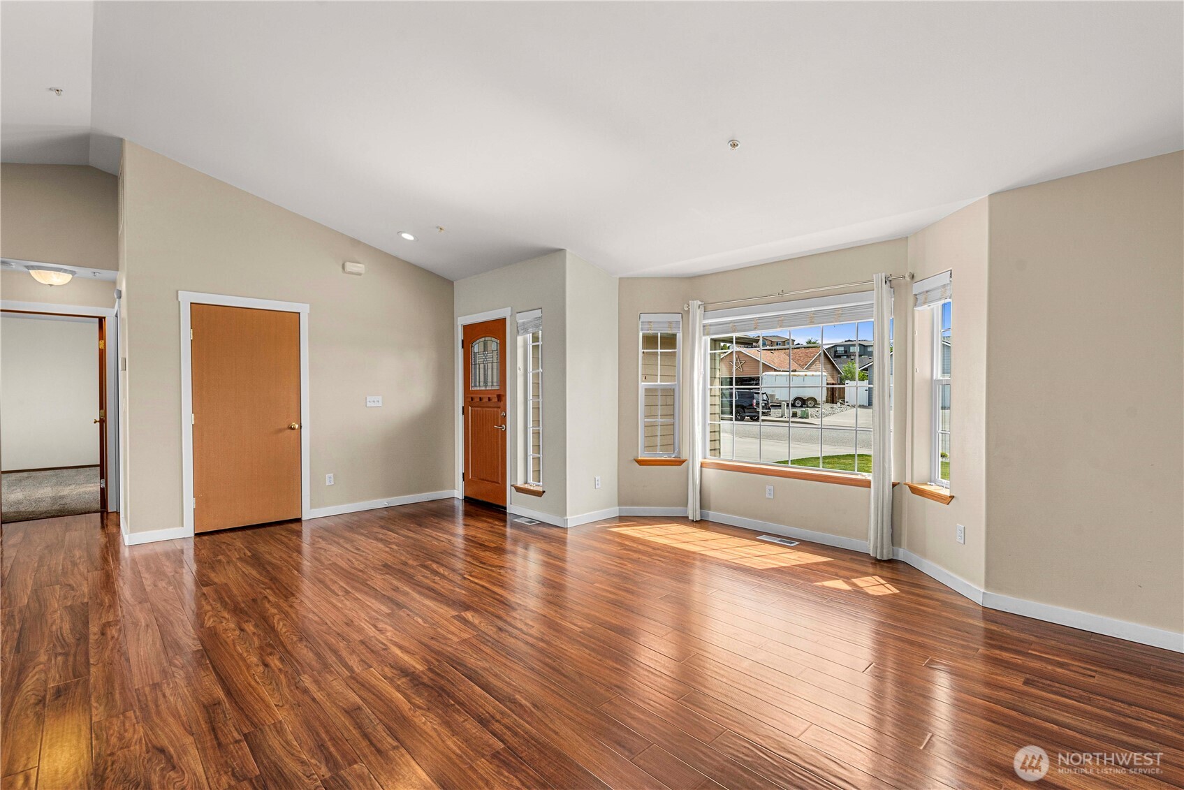 1308 Tractor Loop East Wenatchee, WA 98802 - Photo 7 of 35 a view of an empty room with window and wooden floor