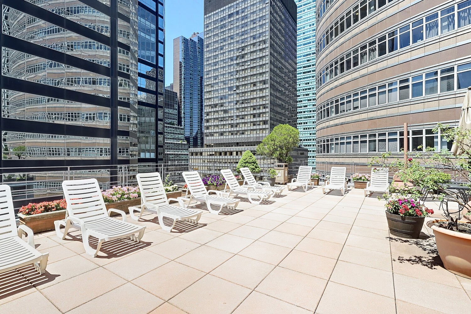 211 East 53rd Street, Unit 3M Manhattan, NY 10022 - Photo 10 of 11 a view of a patio with dining table and chairs and potted plants