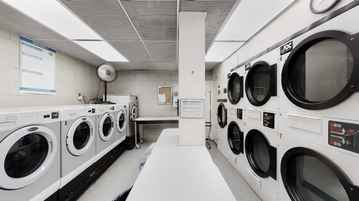 211 East 53rd Street, Unit 3M Manhattan, NY 10022 - Photo 7 of 11 a utility room with dryer and washer