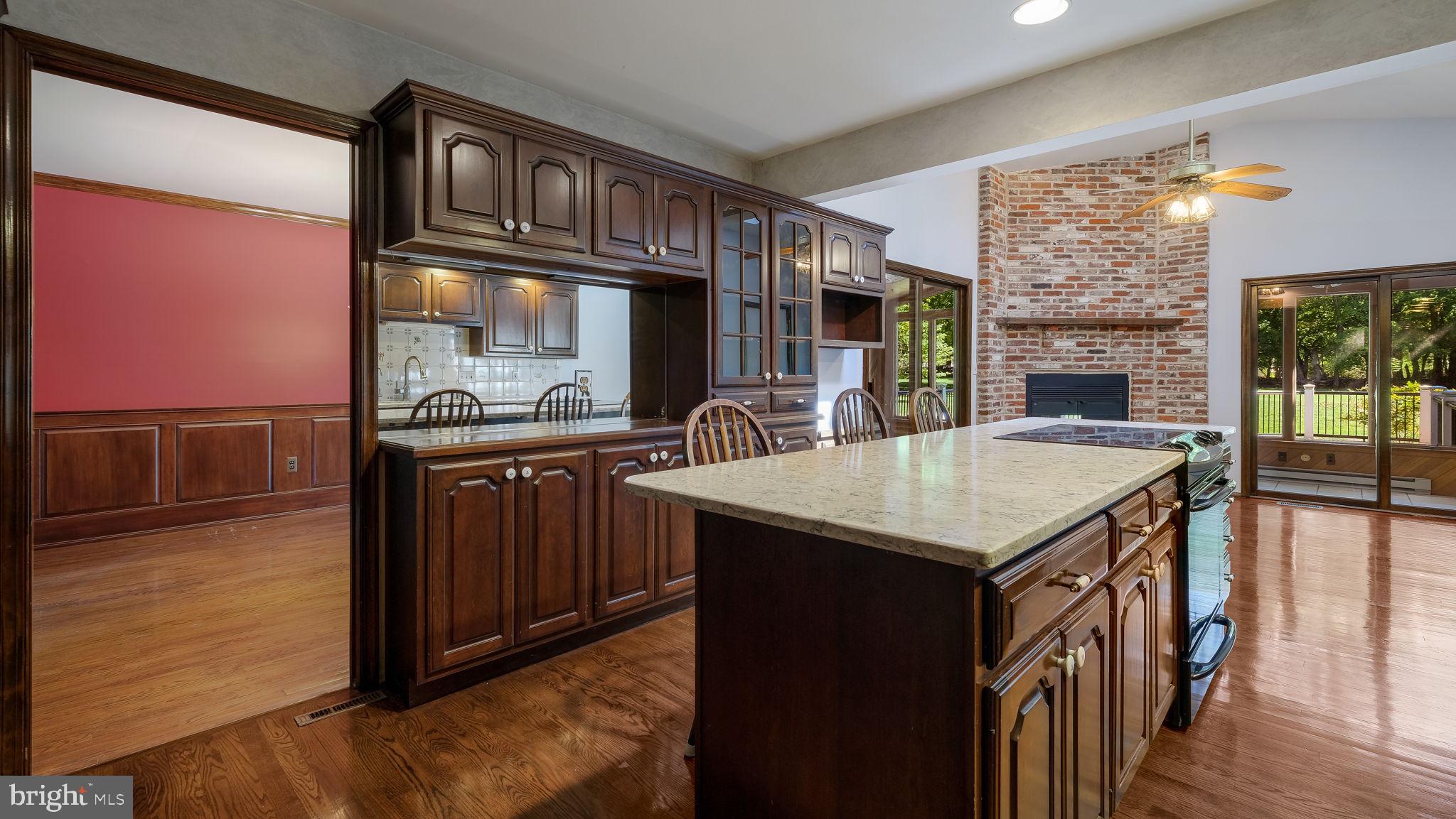 2775 Red Gate Drive Doylestown, PA 18902 - Photo 11 of 38 a kitchen view with granite countertop a stove a kitchen island with a cabinets and wooden floor