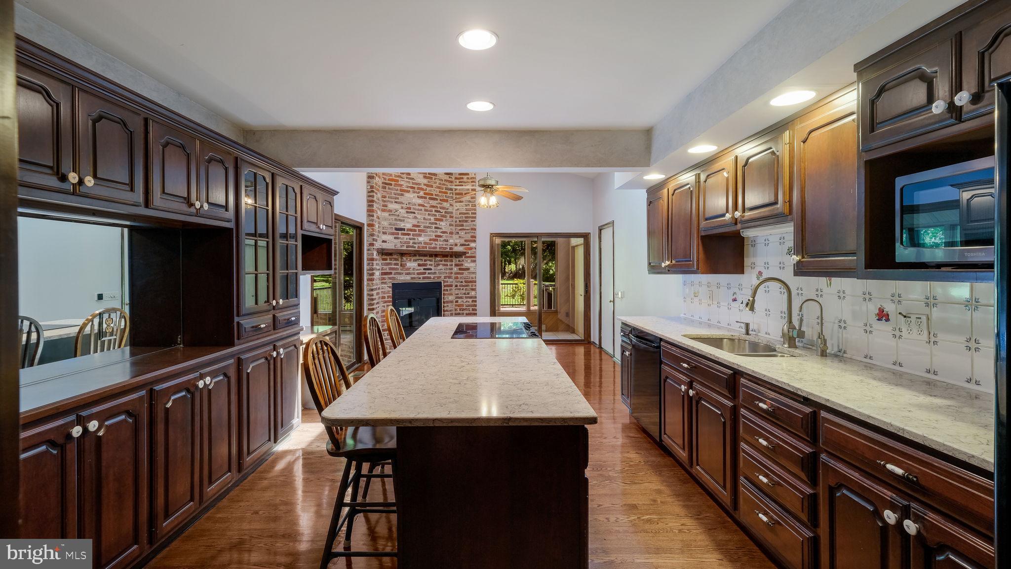 2775 Red Gate Drive Doylestown, PA 18902 - Photo 10 of 38 a kitchen with stainless steel appliances a kitchen island hardwood floor sink stove dining table and chairs