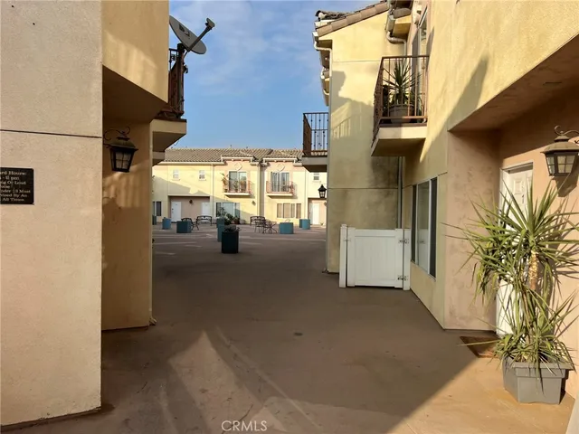 a view of a street with cars parked in front of it