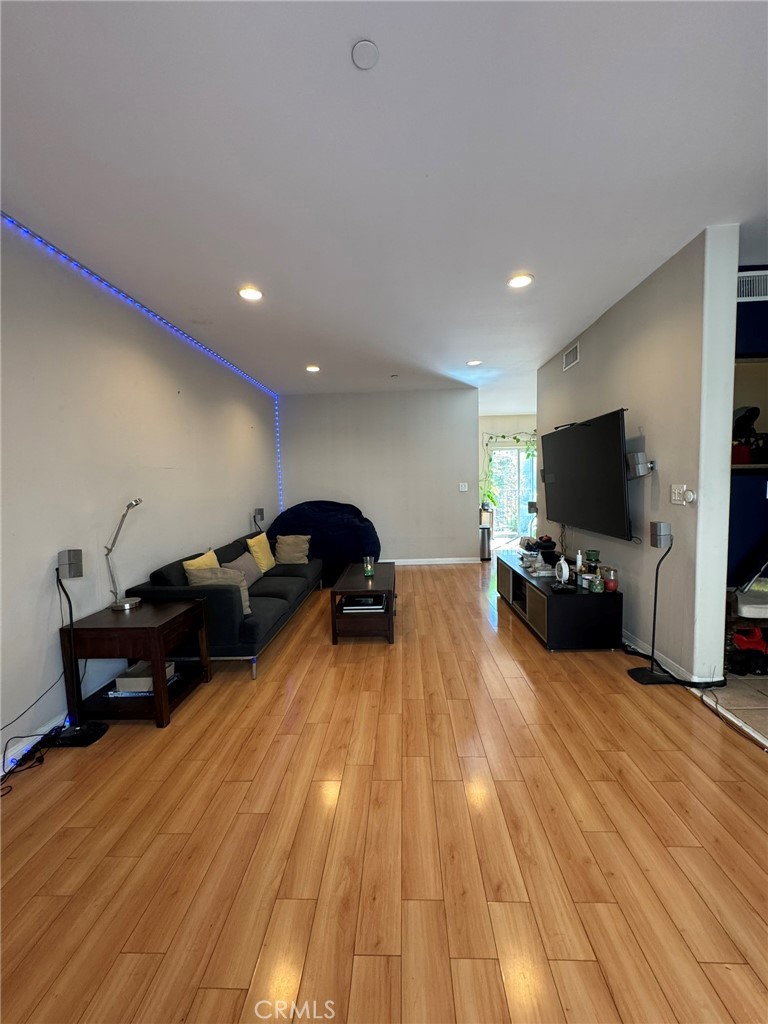12375 Osborne Place, Unit 7 Pacoima, CA 91331 - Photo 7 of 30 a living room with furniture and a flat screen tv