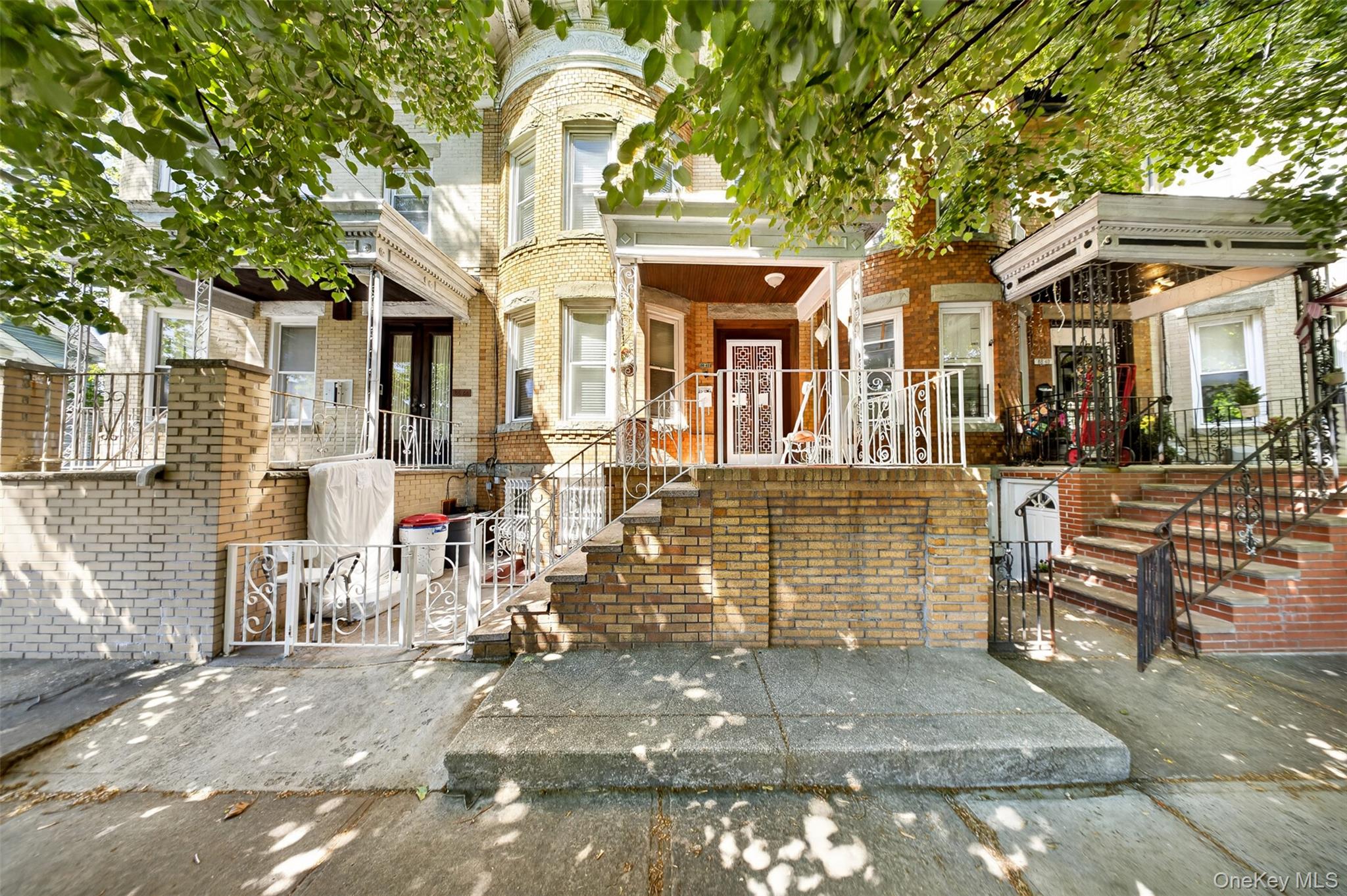 88-42 87th Street Queens, NY 11421 - Photo 1 of 33 a view of a patio with couches table and chairs and potted plants