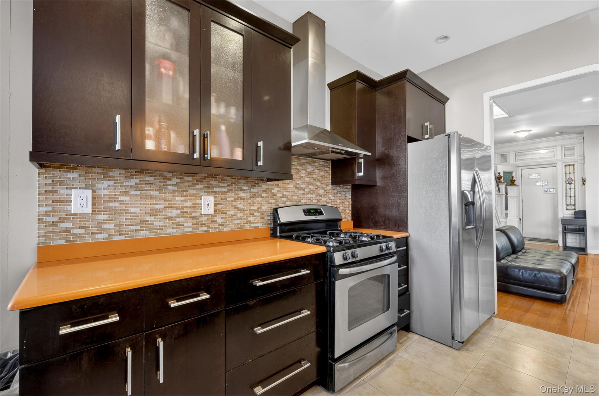 88-42 87th Street Queens, NY 11421 - Photo 11 of 33 a kitchen with a refrigerator and a sink