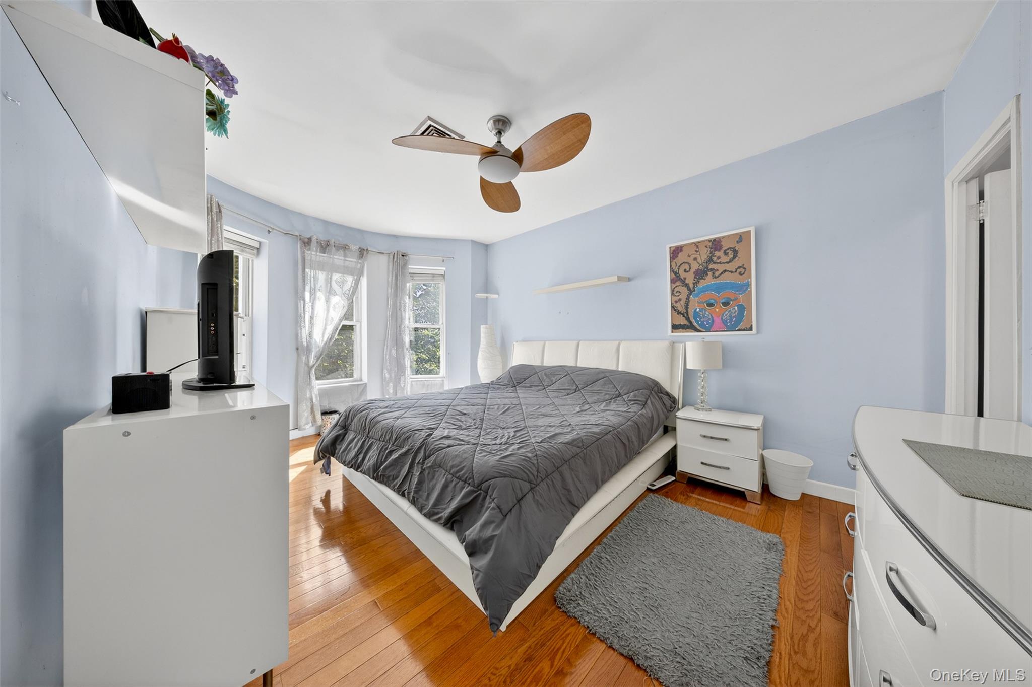 88-42 87th Street Queens, NY 11421 - Photo 18 of 33 a bedroom with a bed and a chandelier