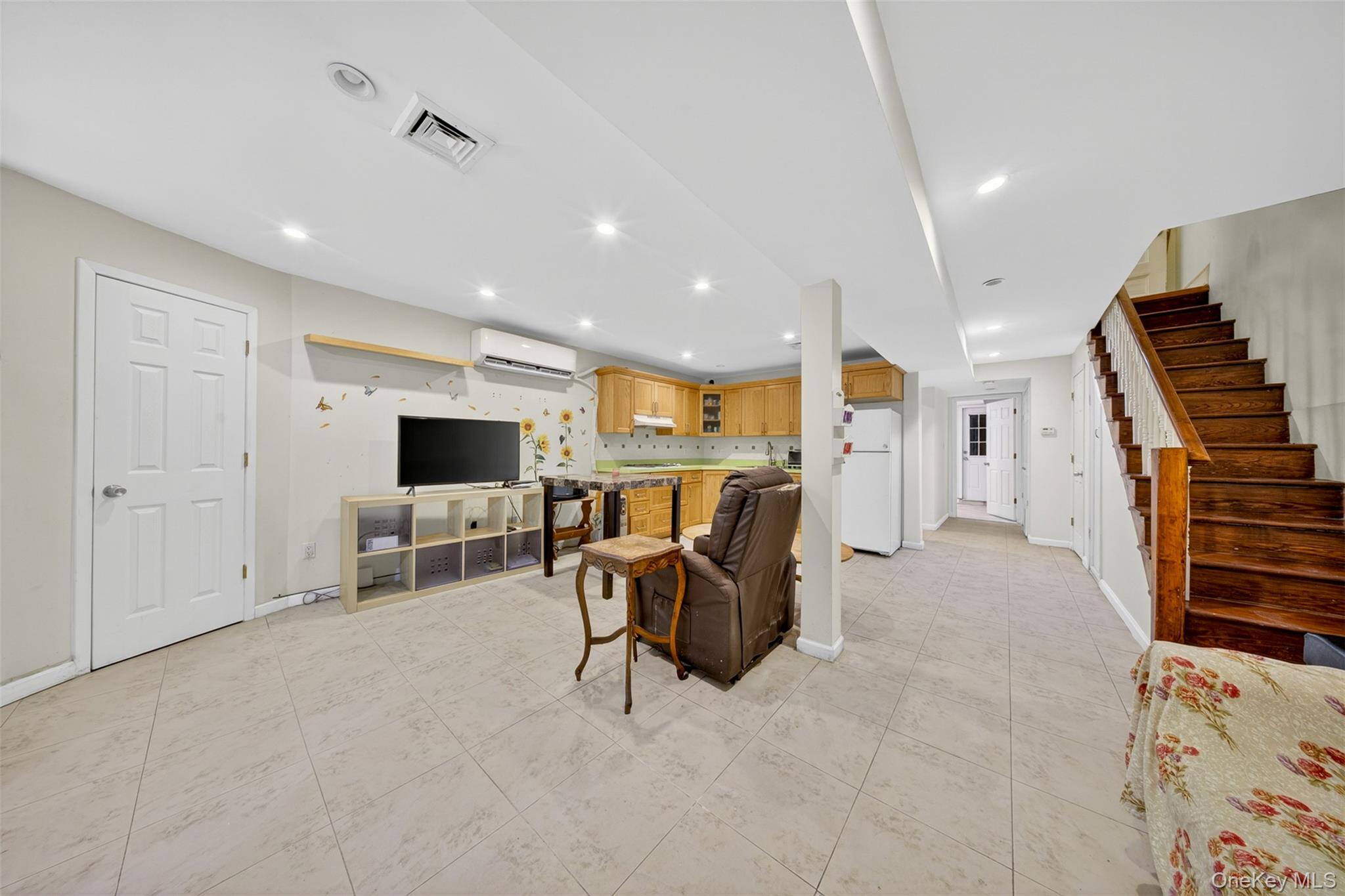 88-42 87th Street Queens, NY 11421 - Photo 22 of 33 a view of a livingroom with furniture and a flat screen tv