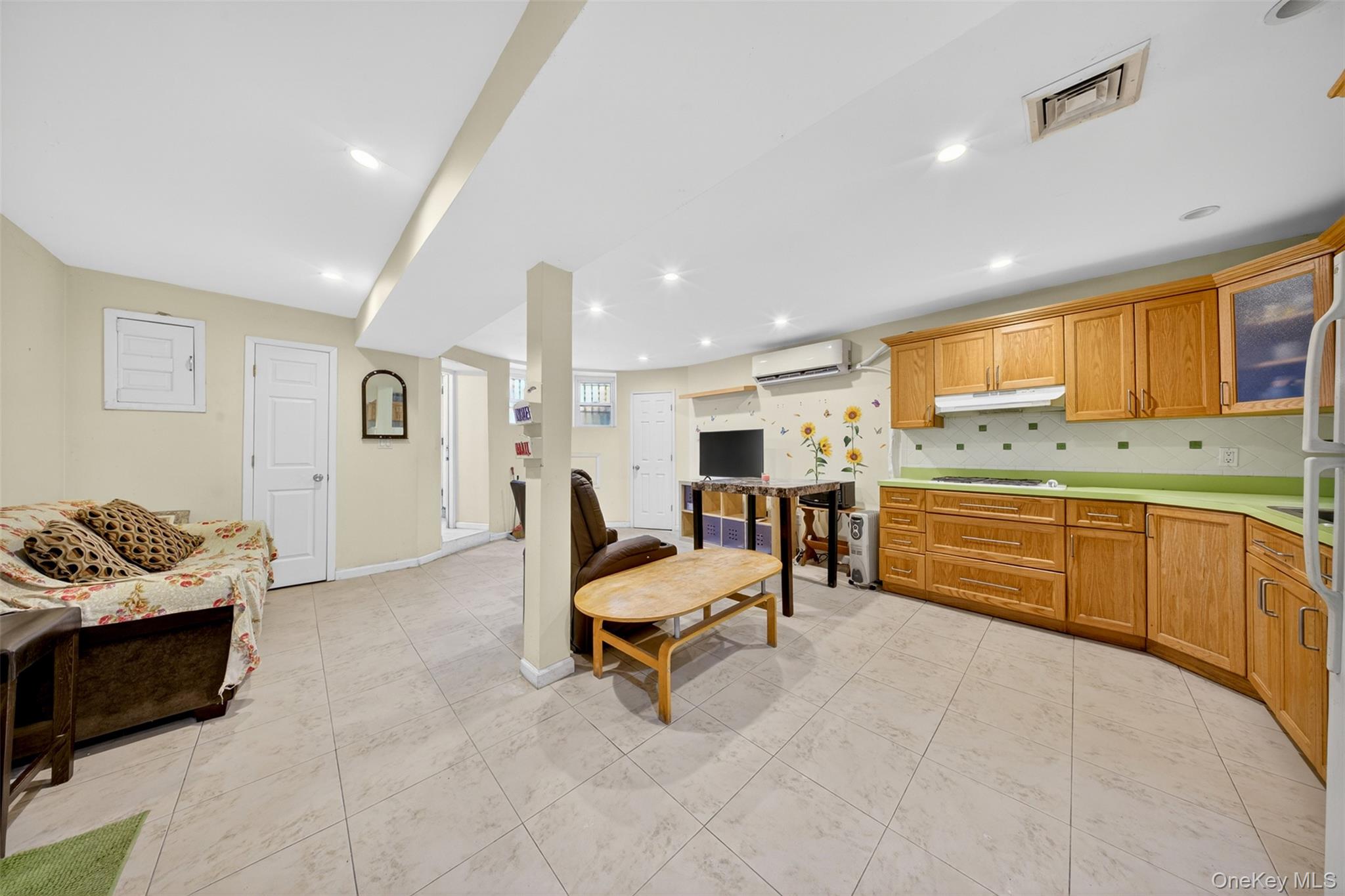 88-42 87th Street Queens, NY 11421 - Photo 23 of 33 a living room with furniture and a kitchen