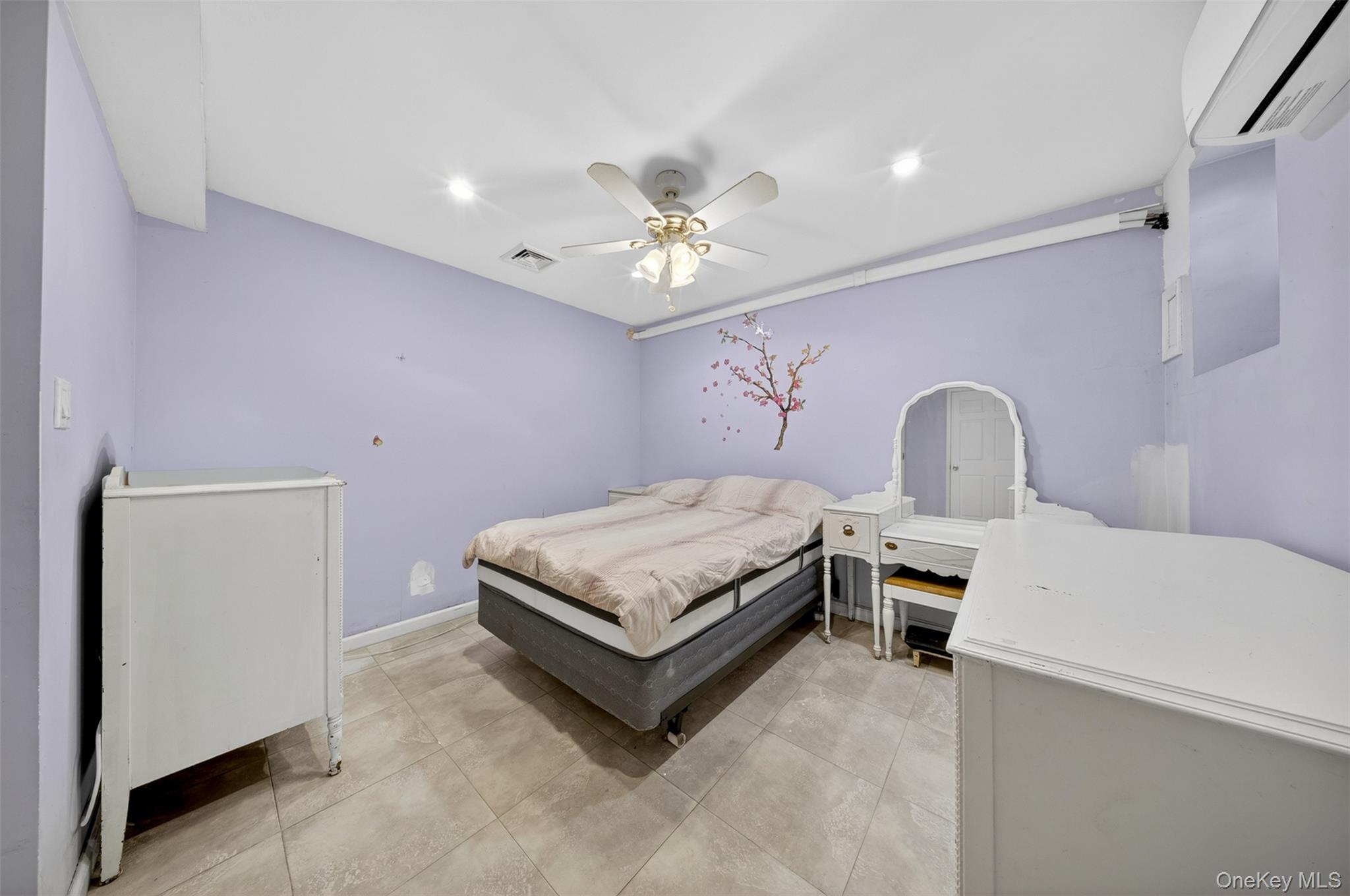 88-42 87th Street Queens, NY 11421 - Photo 24 of 33 a bedroom with a bed and a chandelier