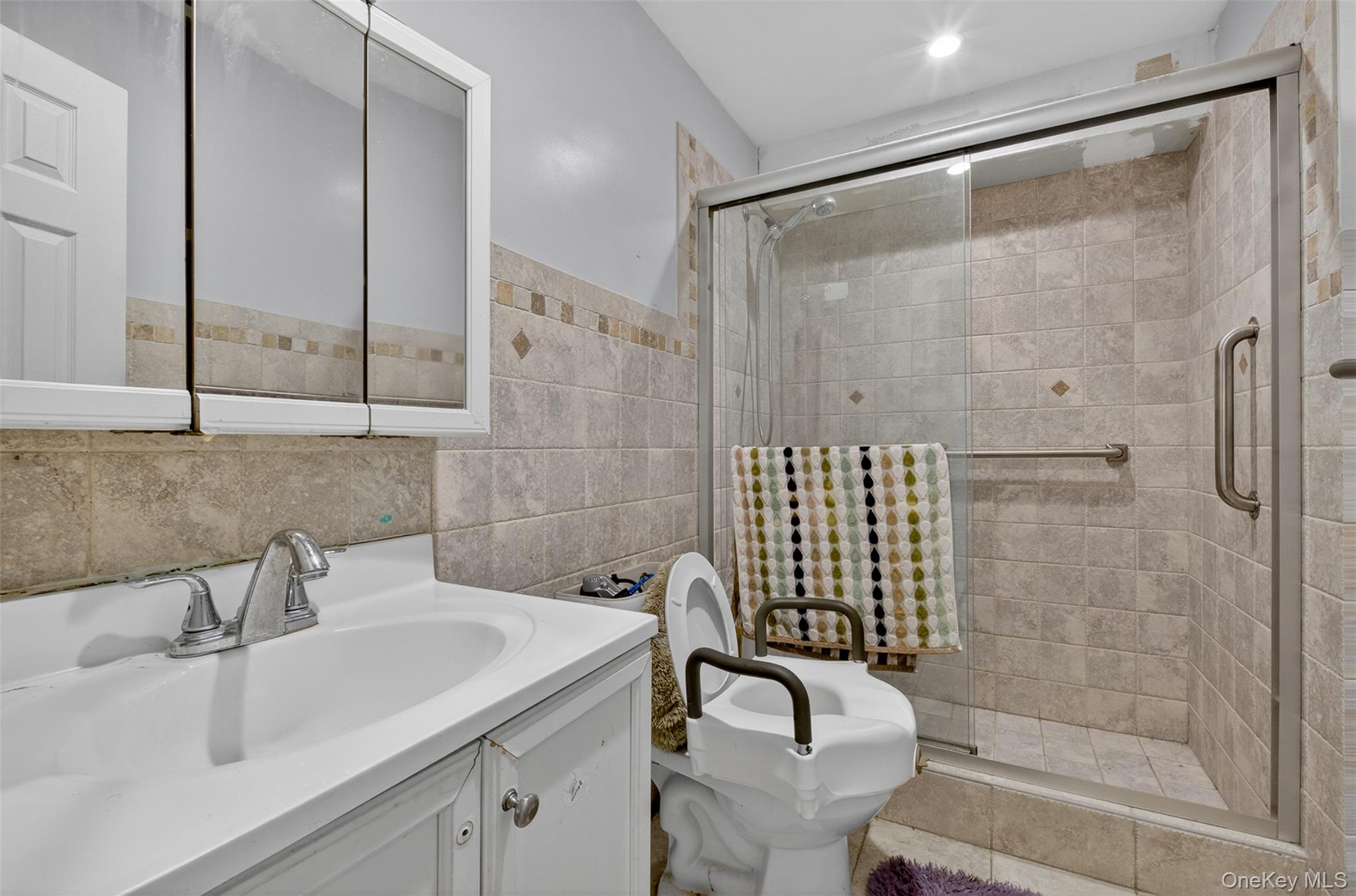 88-42 87th Street Queens, NY 11421 - Photo 25 of 33 a bathroom with a sink shower and a mirror