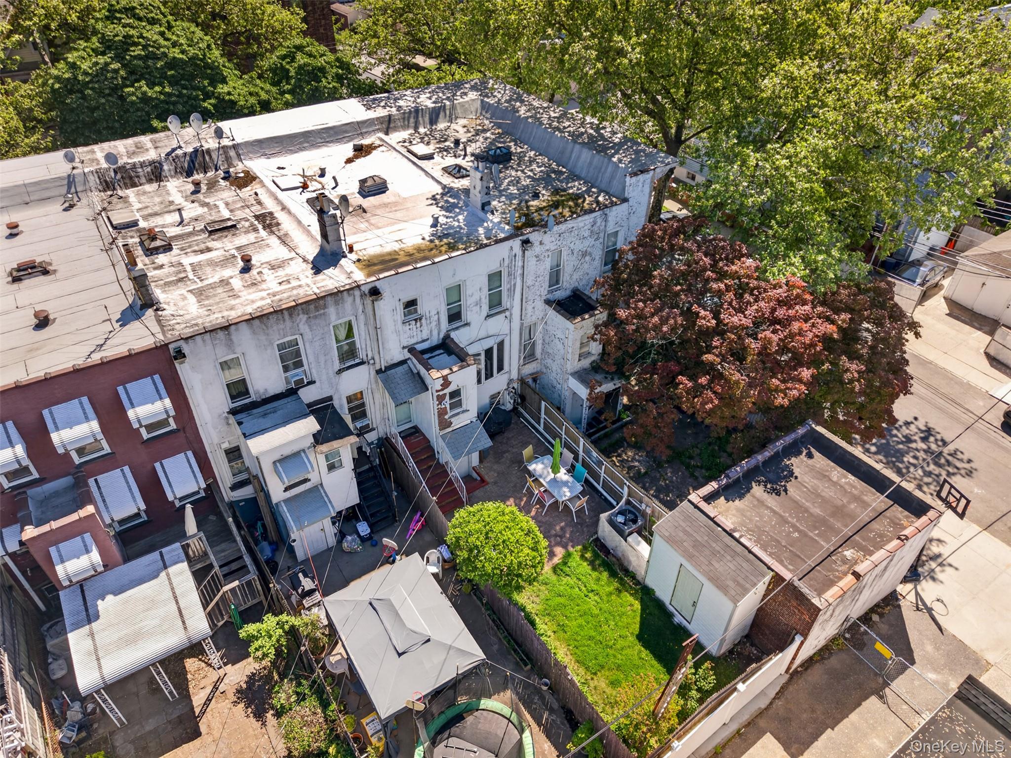 88-42 87th Street Queens, NY 11421 - Photo 29 of 33 an aerial view of a house with a yard