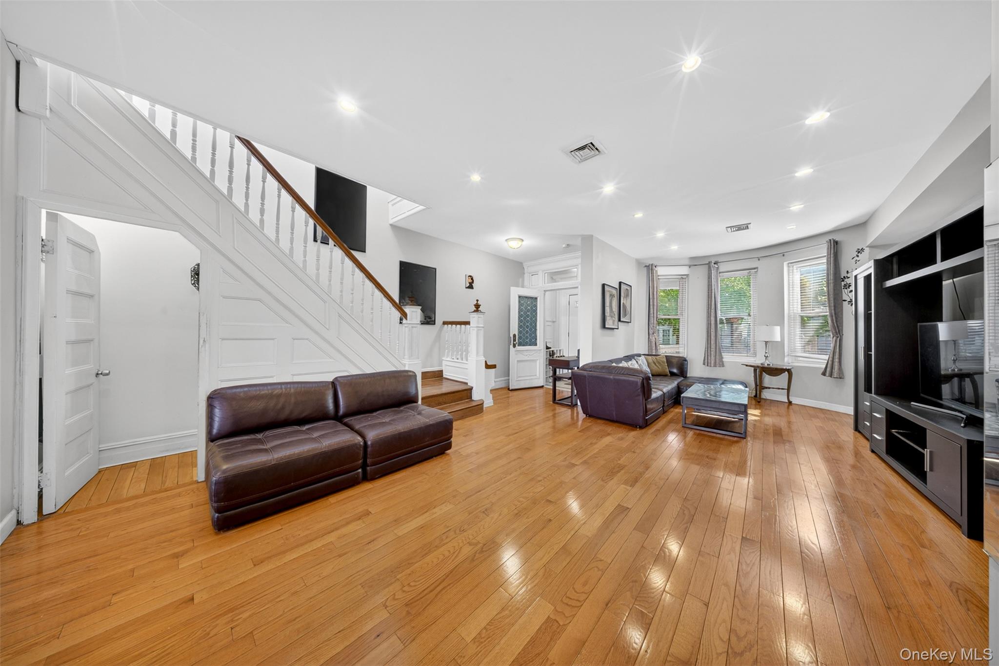 88-42 87th Street Queens, NY 11421 - Photo 5 of 33 a living room with furniture and a flat screen tv